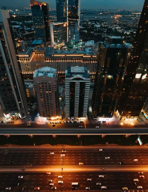 Aerial night view of a city skyline, representing energy and infrastructure projects