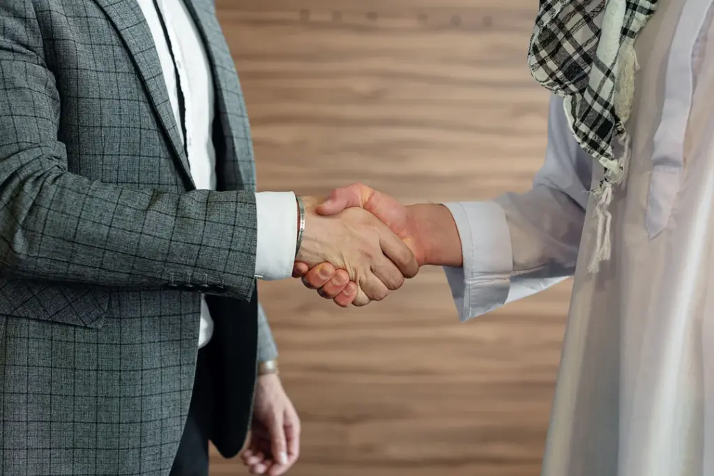 International business handshake in traditional attire