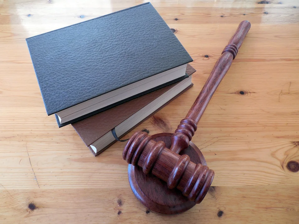 Judge's gavel resting on law books on a wooden desk