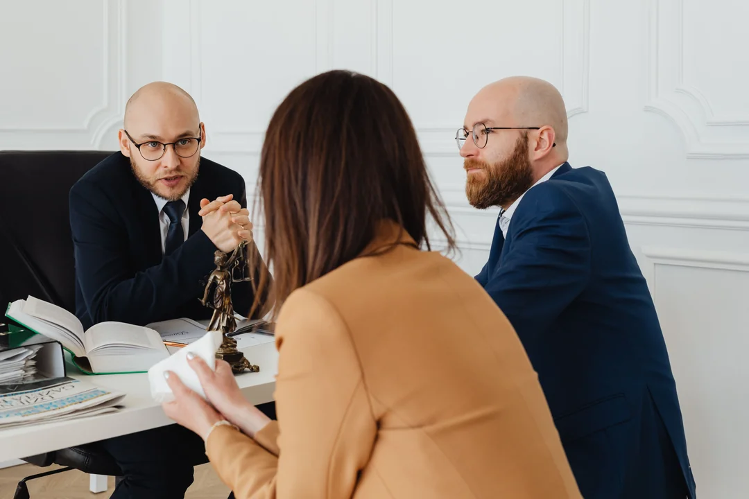 Lawyers consulting a client in an office meeting